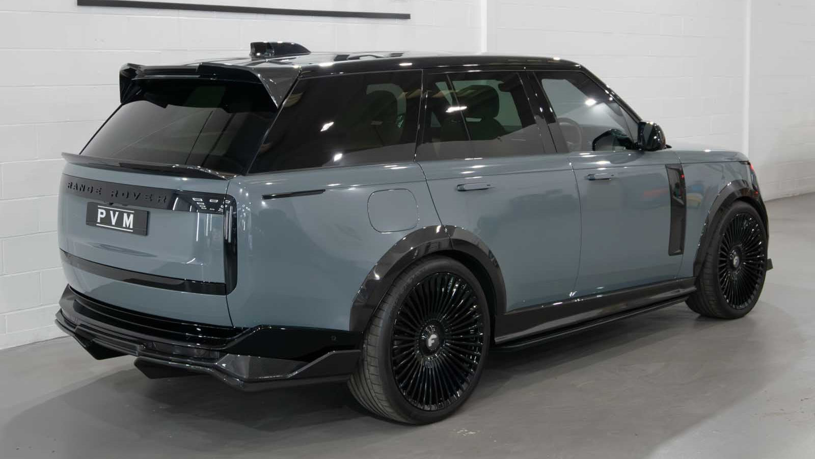 Luxury SUV with 'PVM' branding in a showroom setting